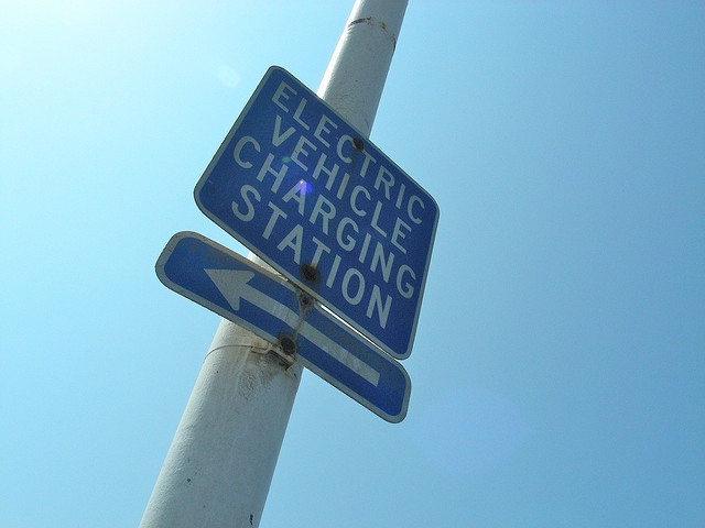 A sign pointing the direction to an Electric C... A sign pointing the direction to an Electric Car